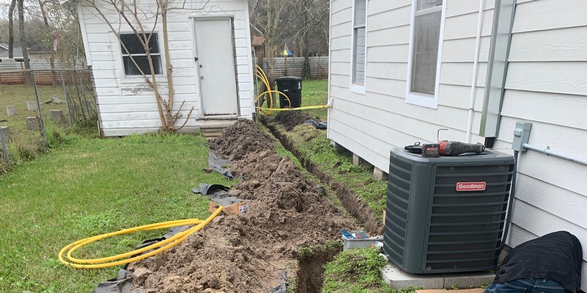 Flat-Out technician performing emergency condenser repair and utility trenching in Montgomery County near Conroe, TX