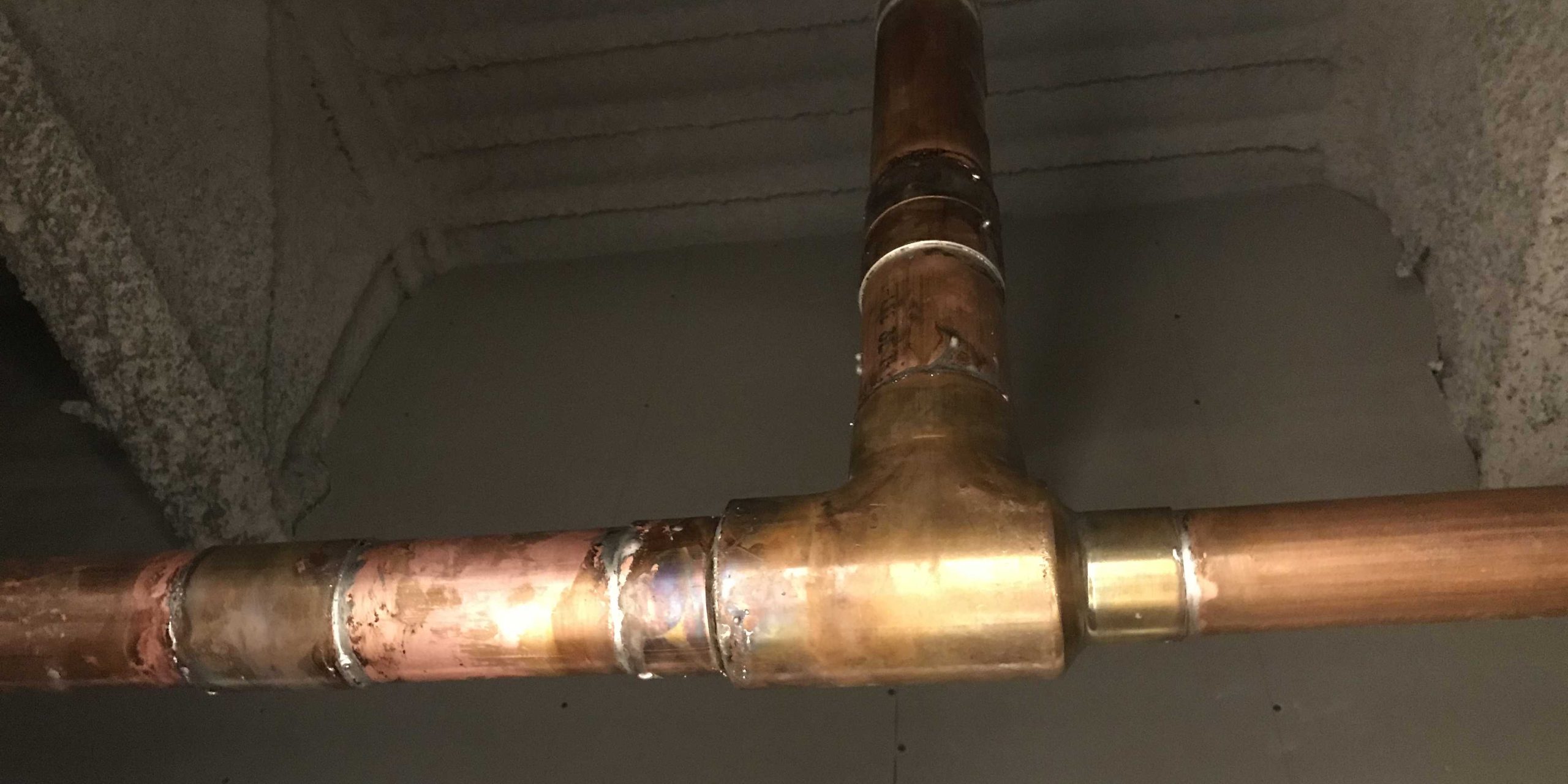 Flat-Out technician brazing high-pressure copper refrigerant line connections in Cypress, TX